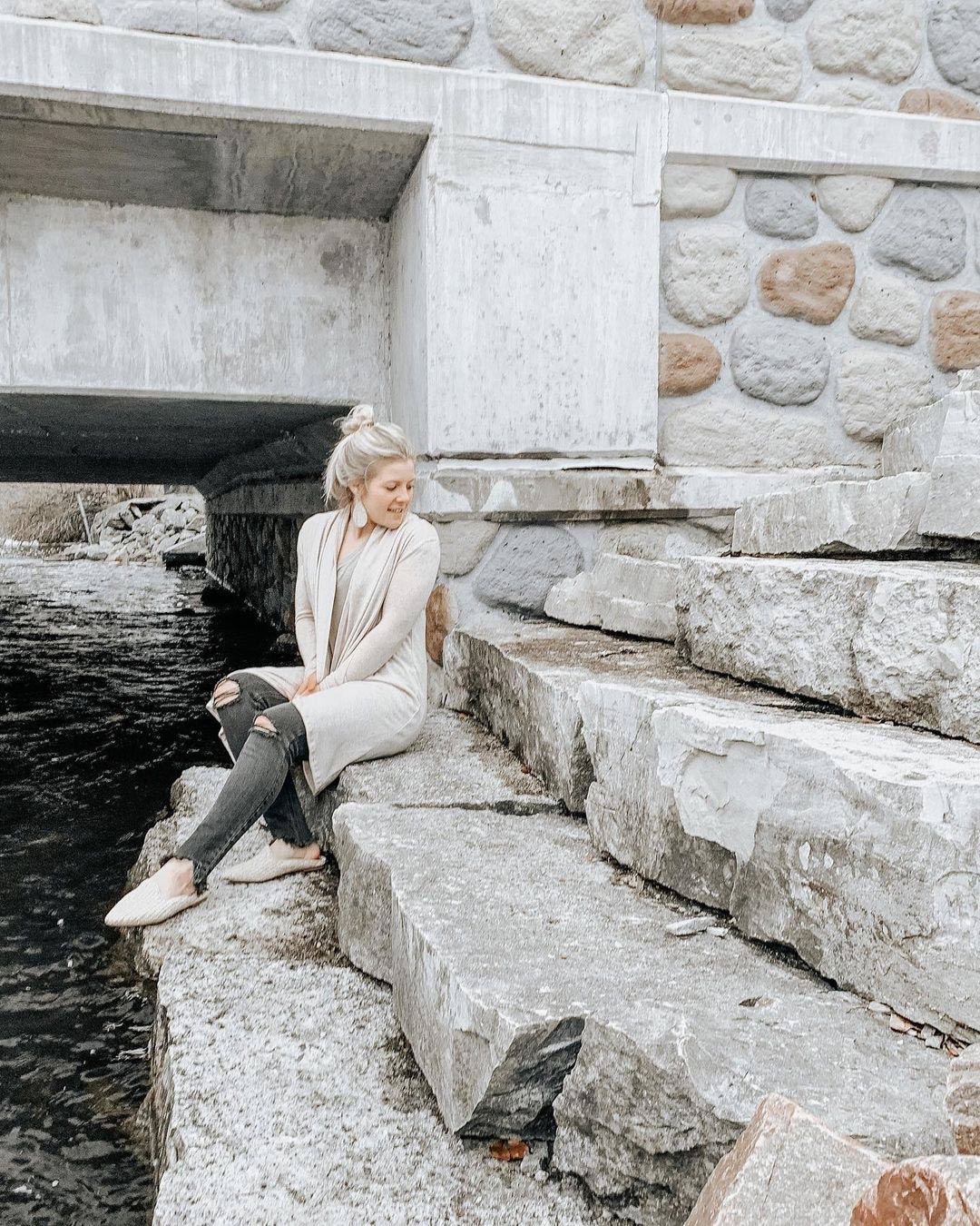 mikayla sitting near river steps